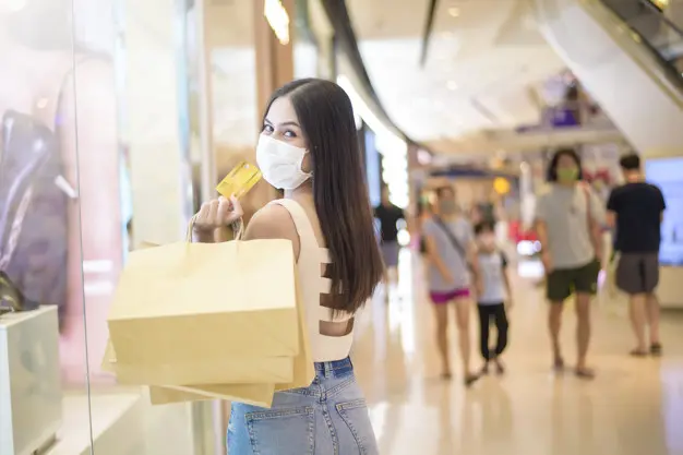 portrait of beautiful woman is wearing face mask in shopping center