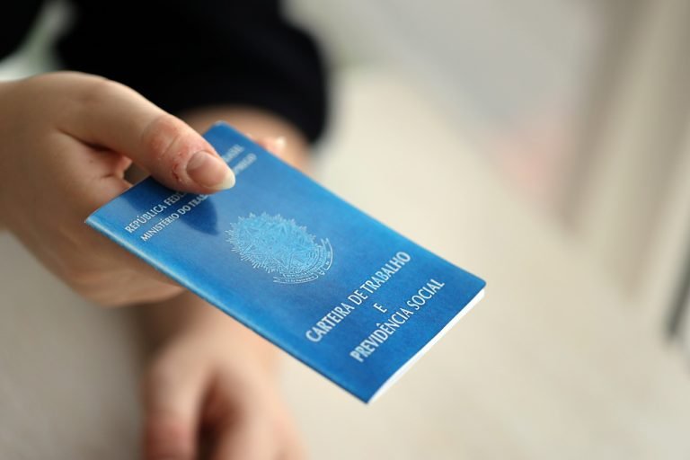 Woman boss gives a brazilian work card and social security blue book to us in employment office