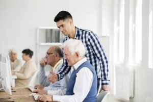 Man checking senior's progress