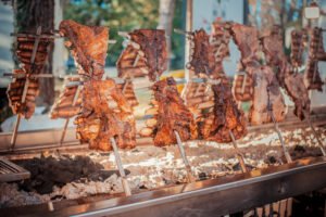 Traditional Argentinian asado roasted lamb grilled meat.