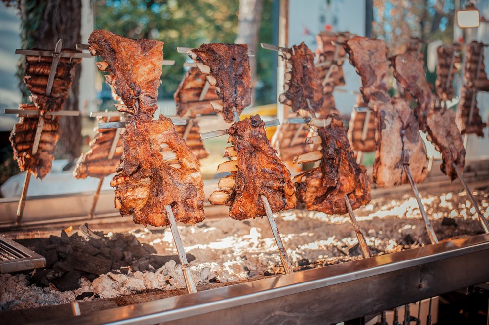 Traditional Argentinian asado roasted lamb grilled meat.