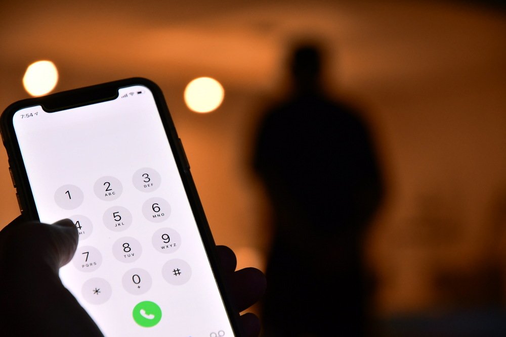 shadowy-figure-behind-illuminated-smartphone-dialp-2026-03-13-01-56-20-utc (1)