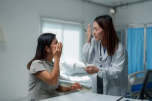Doctor comforting crying patient in hospital room
