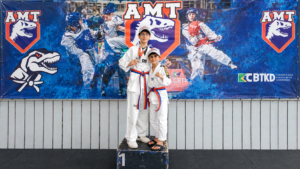 Campeões mirins no pódio de taekwondo